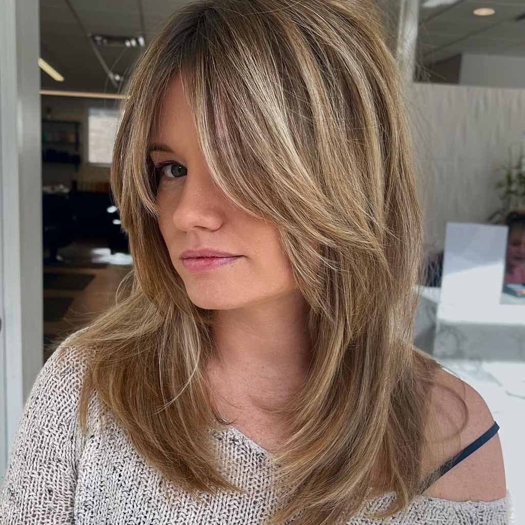 a girl with balayage wolf cut and face layers