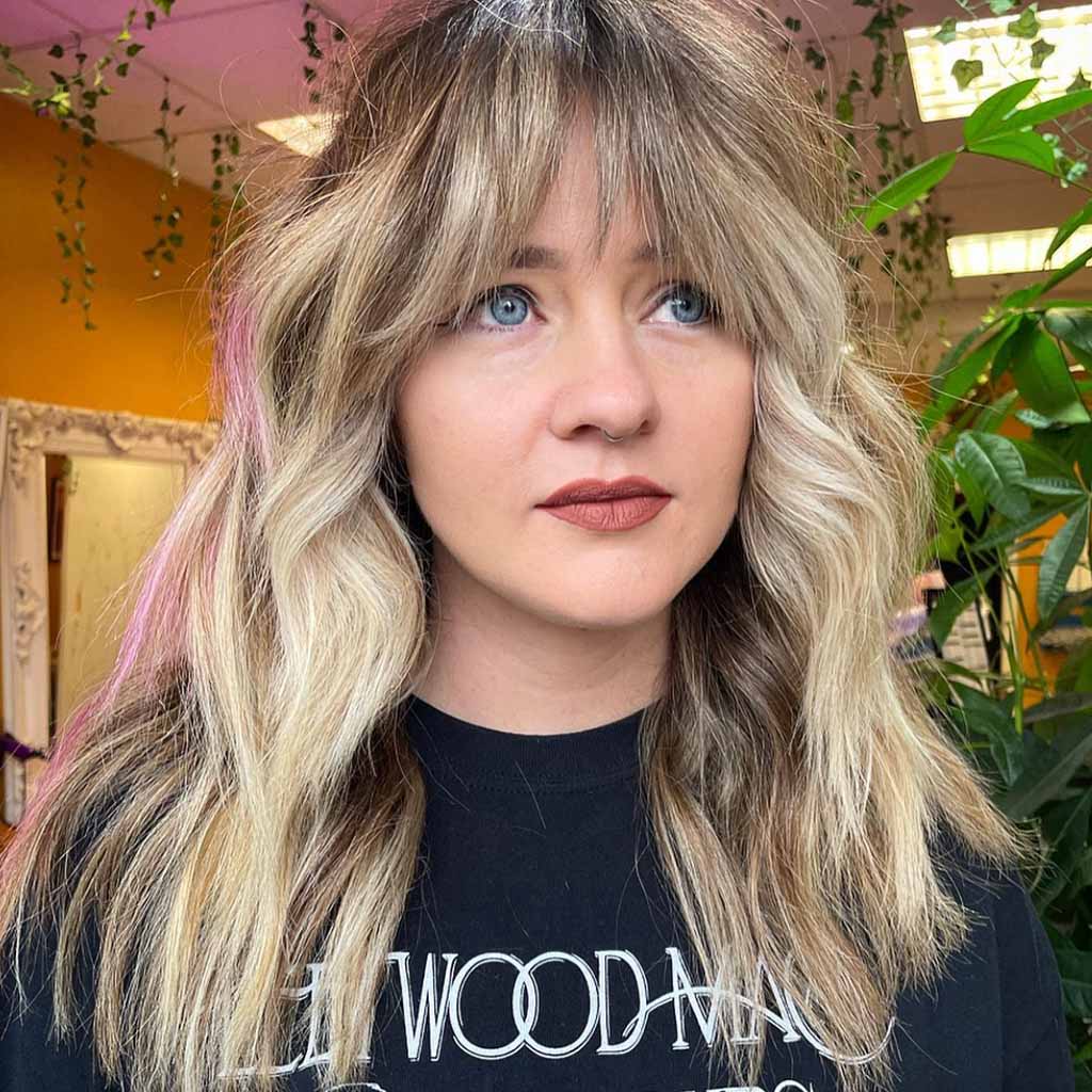 A girl with chunky color wolf cut and blue eyes
