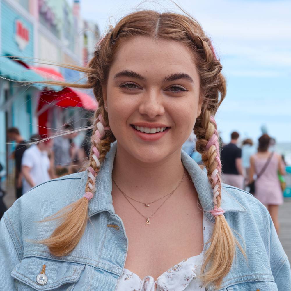 Cute braided pigtails with pink ribbon accents, playful ribbon hairstyle for casual days