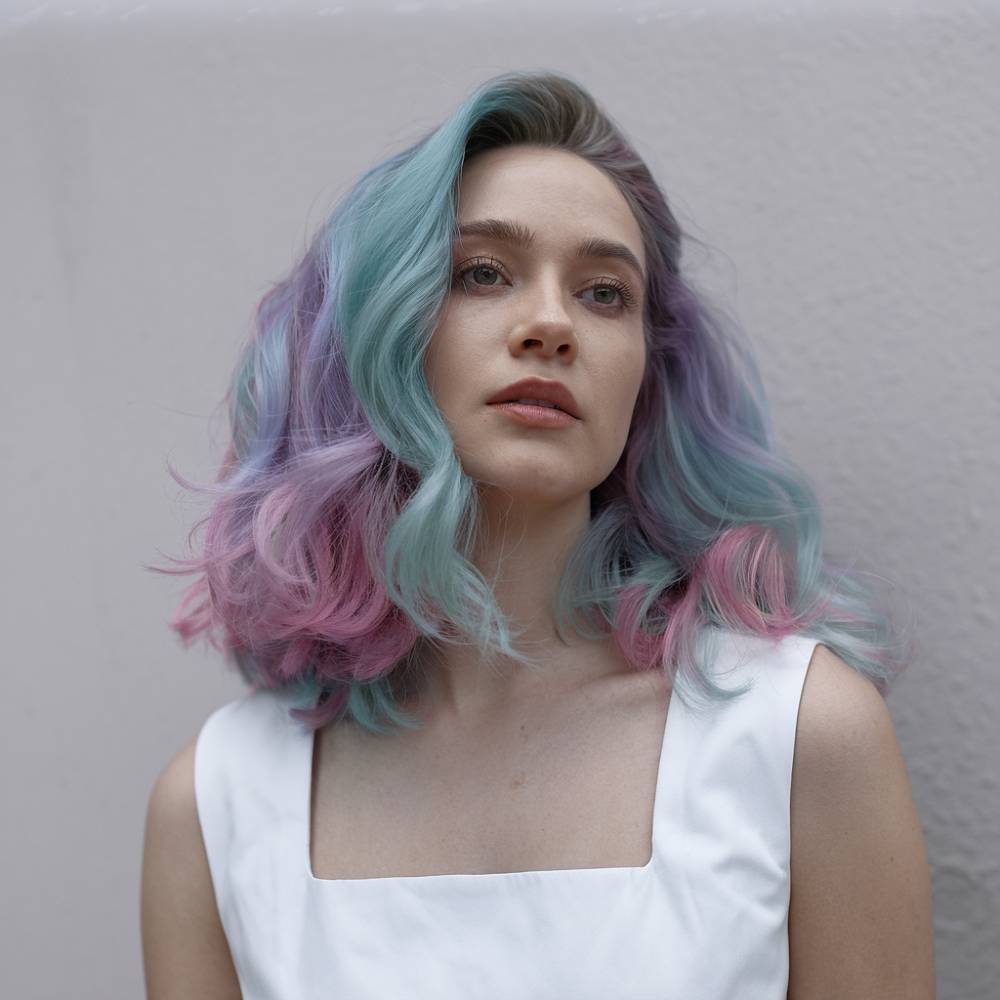 Cosmic-inspired pastel hair with a blend of blue, pink, and purple tones for a soft, dreamy galaxy effect